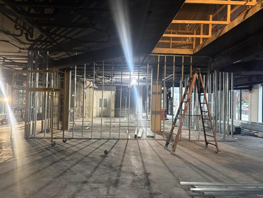 Framed walls and scaffolding inside 10708 Main Street, October 2026
